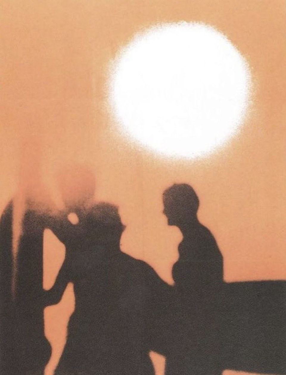 Two people in silhouette against a low sun